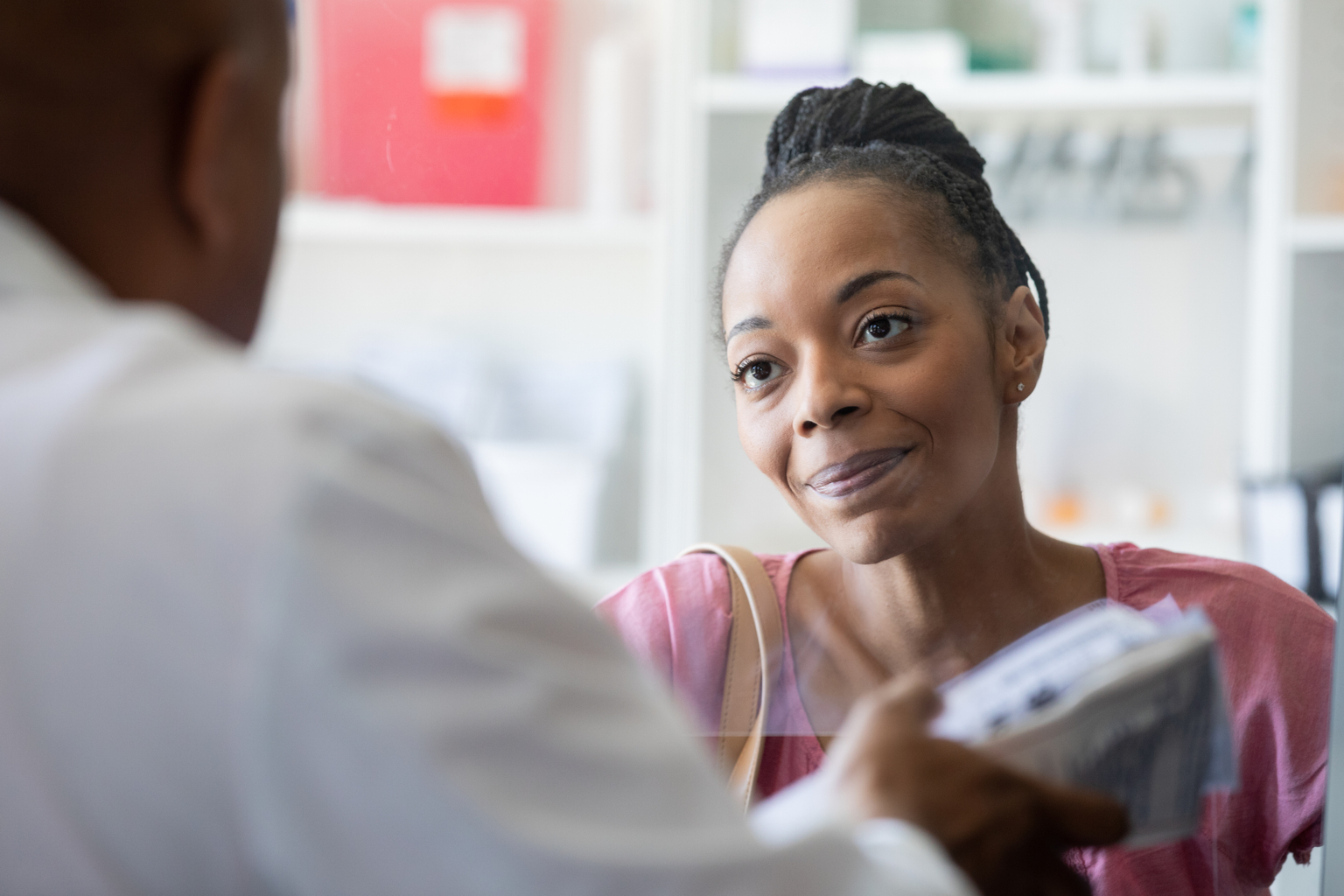 Portrait of a woman receiving her medication from the local pharmacy.