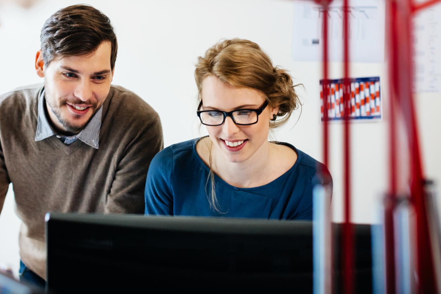 Two young start up people in their office