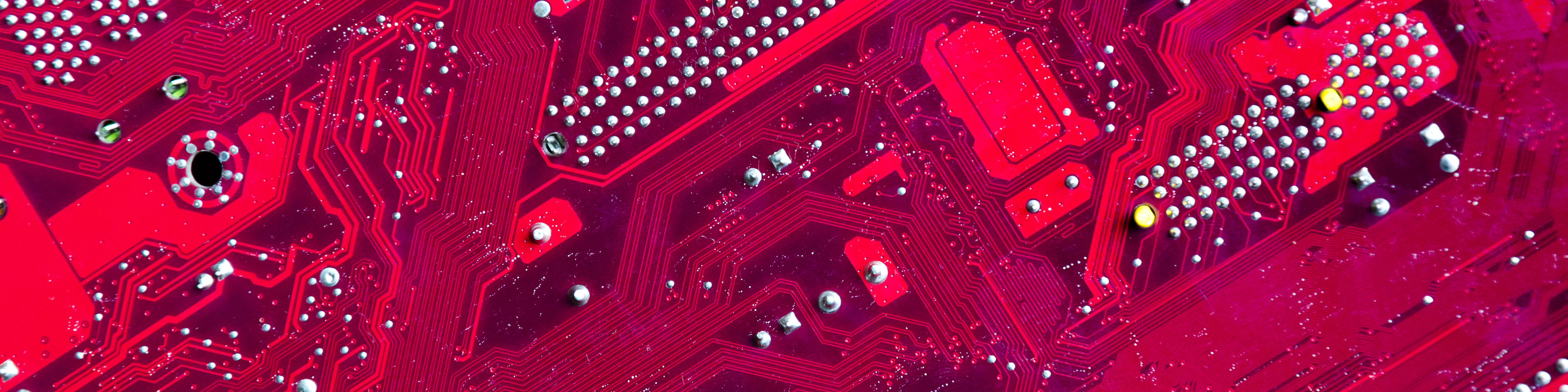 Close-up of a red computer circuit board 